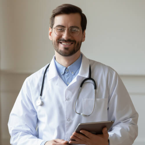 smiling young male doctor in white medical uniform