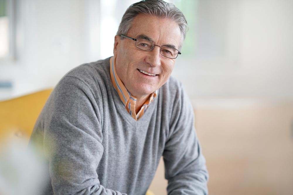 Smiling senior man with eyeglasses relaxing