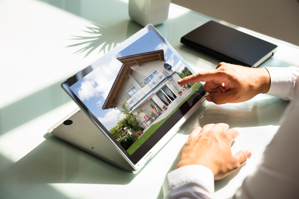 Close-up,Of,Businessman's,Hand,Checking,House,On,Laptop